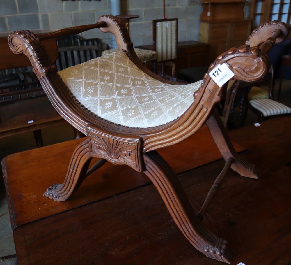 An early 20th century Anglo Burmese teak X frame stool, width 74cm